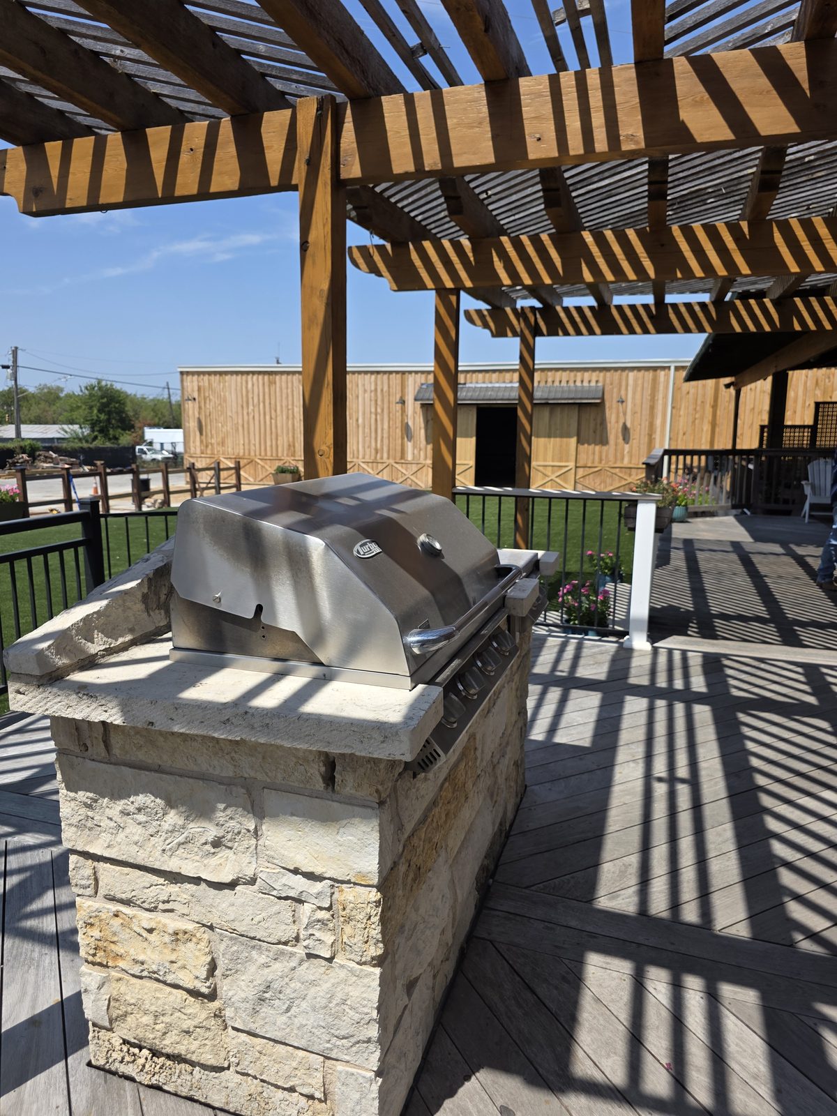 The built-in stone BBQ grill on the covered deck